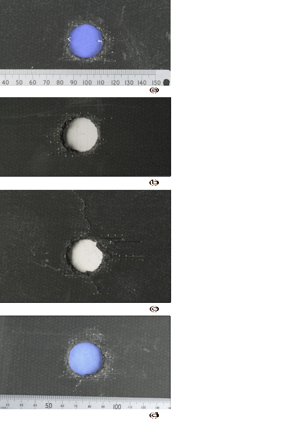 Visible damage caused by 20-mm projectiles. (a) Exit side, shot with no structural loading; (b) and (c) Exit sides, shot with 7,000 and 9,000 structural loading respectively; and (d) Exit side, 9,000 structural loading applied after the panel was shot with no structural loading.