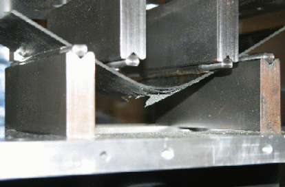 Failure pattern in residual stiffness and strength test. The specimen was shot with a 20-mm projectile with no structural load prior to the testing.