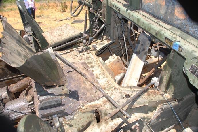 Driver and passenger seats still intact in Humvee with mesh.