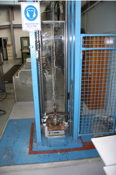 The experimental set up of the drop test rig at DSTO Fishermans Bend. The drop mass is at the impact point with the test foam cushion.