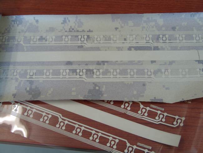 Image of a prototype conductive thin film layer with transparent photo mask used on a textile material.